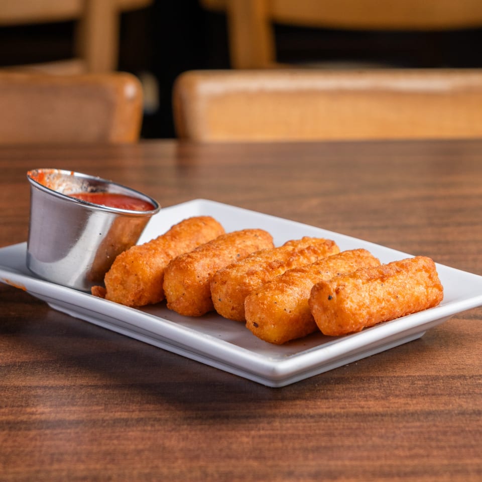 DeAngelo's Neapolitan Italian Eatery's crispy mozzarella sticks with a side of marinara sauce.